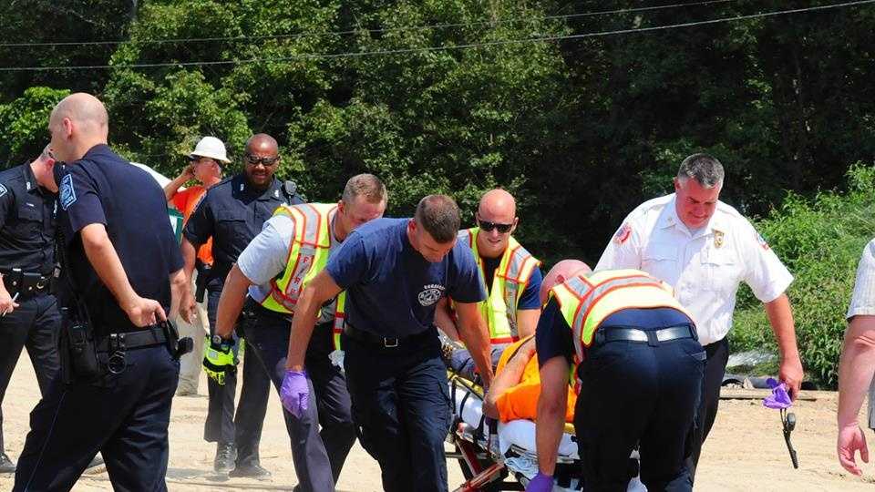 Photos: Driver injured after dump truck tips over