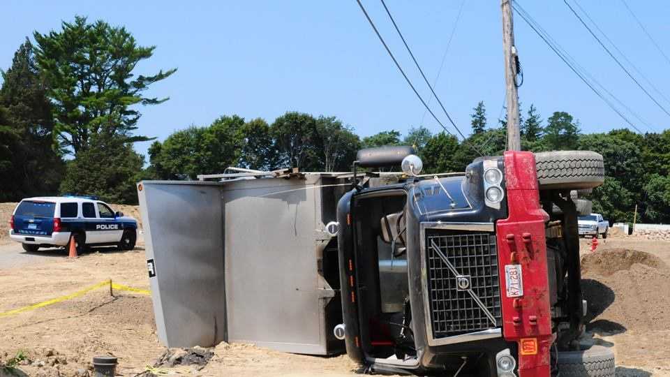 Photos Driver injured after dump truck tips over