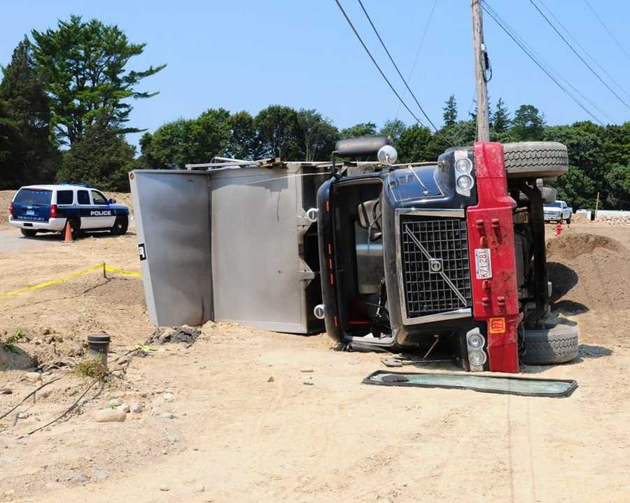 Photos Driver injured after dump truck tips over