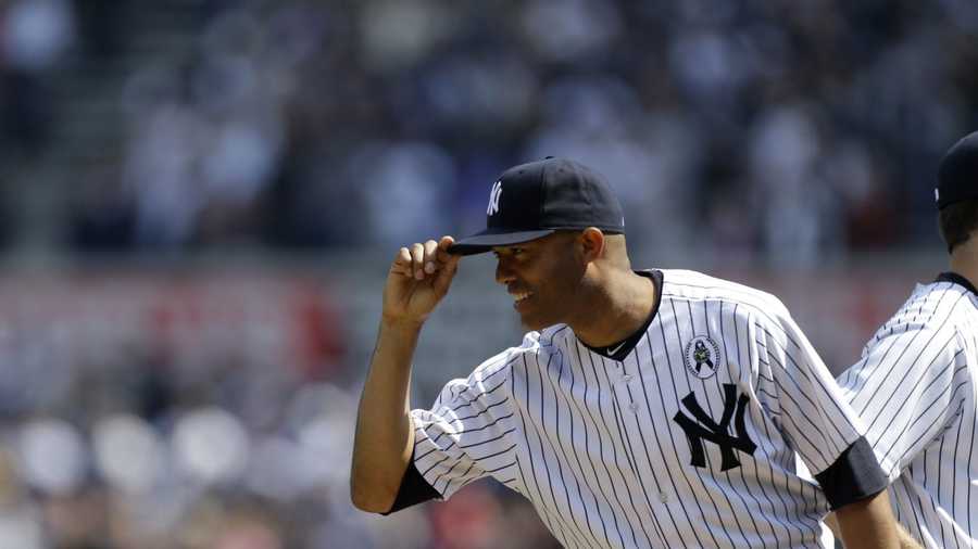 New York Yankees relief pitcher Mariano Rivera (42) tips his cap to Red Sox players at an Opening Day baseball game at Yankee Stadium in New York, Monday, April 1, 2013.