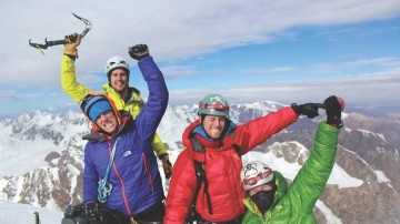 Westford native Rob Gleich, at left in rear, celebrates with, from left, Austin Lines, Zach Matthay and Jeffrey Longcor, at the top of a Himalayan peak in Kyrgyzstan on July 23. 