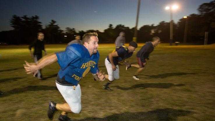 Mike Wolongevicz, 42, of Hanover runs a drill with fellow members of the Coastal Chiefs in Hanover on Tuesday, Sept. 17, 2013.