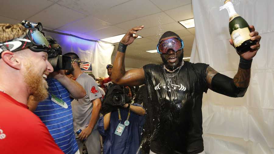 Boston Red Sox 's David Ortiz, right, is sprayed with champagne.