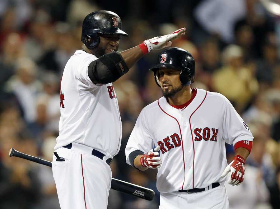 The Boston Red Sox's Shane Victorino (18) tosses his helmet after