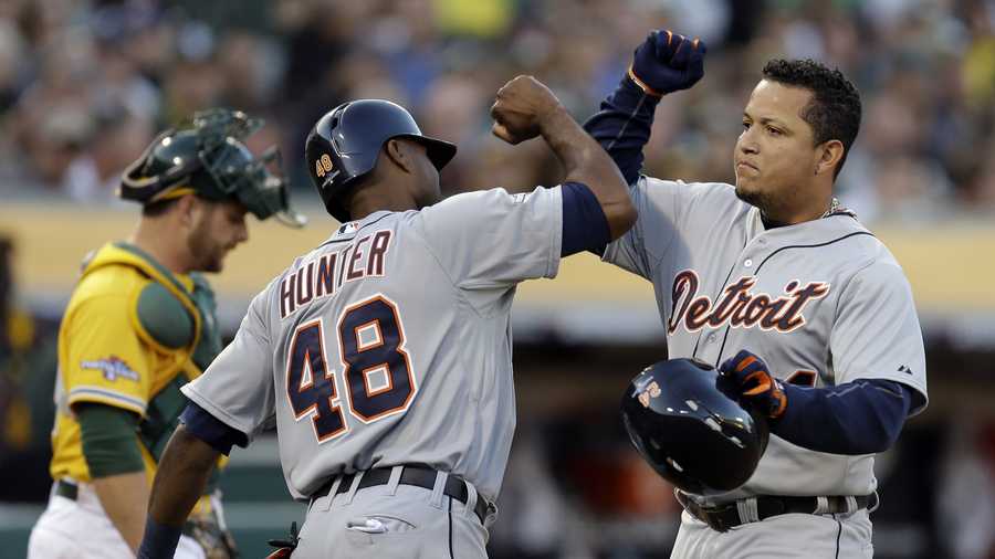 Detroit Tigers Miguel Cabrera (24) celebrates with teammate Torii Hunter (48) after he scored a two run home run that also scored Hunter in the fourth inning of Game 5 of an American League baseball division series against the Oakland Athletics in Oakland, Calif., Thursday, Oct. 10, 2013. 