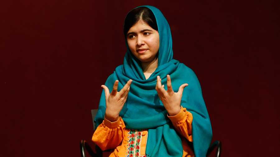 Malala Yousafzai gestures as she speaks to an audience during a discussion of her book, "I am Malala" hosted by the John F. Kennedy Library and held at Boston College High School Saturday, Oct. 12, 2013, in Dorchester, Mass.