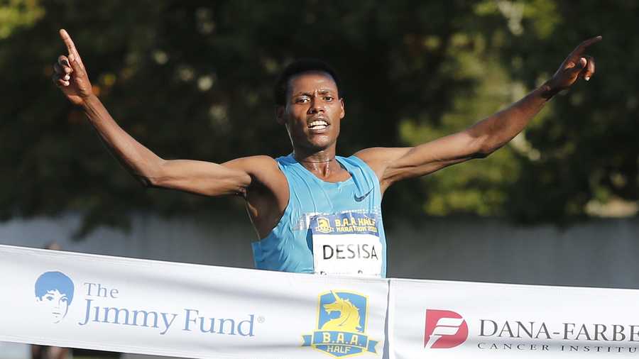 Reigning Boston Marathon champion Lelisa Desisa, of Ethiopia, wins the Boston Athletic Association Half Marathon, Sunday, Oct. 13, 2013.