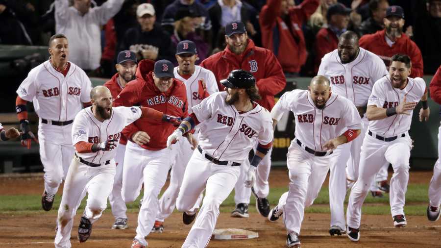 Boston Red Sox players run after Jarrod Saltalamacchia after Saltalamacchia hits the game winning single during Game 2 of the American League baseball championship series against the Detroit Tigers Sunday, Oct. 13, 2013, in Boston. The Red Sox won 6-5.