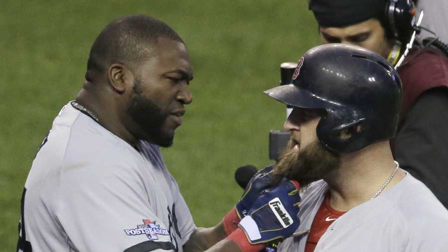 Boston Red Sox's David Ortiz pulls on the beard of Mike Napoli after Napoli hits a home run in the seventh inning during Game 3 of the American League baseball championship series against the Detroit Tigers, Oct. 15, 2013, in Detroit. 