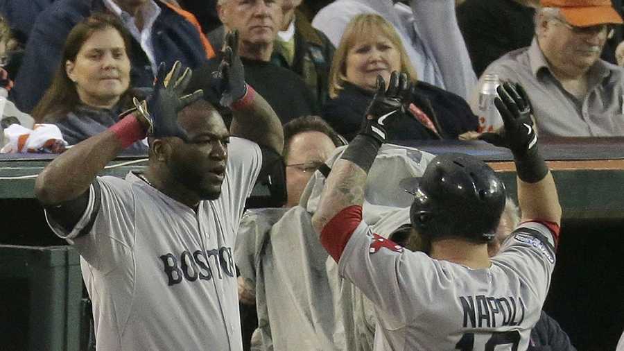 Boston Red Sox's David Ortiz congratulates Mike Napoli after Napoli hits a home run in the seventh inning during Game 3 of the American League baseball championship series against the Detroit Tigers Tuesday, Oct. 15, 2013, in Detroit. 