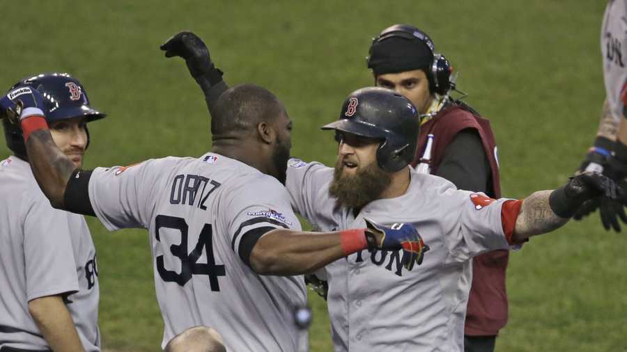 Boston Red Sox's David Ortiz celebrates with Mike Napoli after Napoli hits a home run in the seventh inning during Game 3 of the American League baseball championship series against the Detroit Tigers Tuesday, Oct. 15, 2013, in Detroit. 