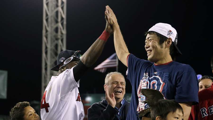 Boston Red Sox relief pitcher Koji Uehara, right, gets a high five from David Ortiz after the Red Sox beat the Detroit Tigers 5-2 in Game 6 of the American League baseball championship series on Saturday, Oct. 19, 2013, in Boston. Uehara was named the series MVP, and the Red Sox advance to the World Series. 