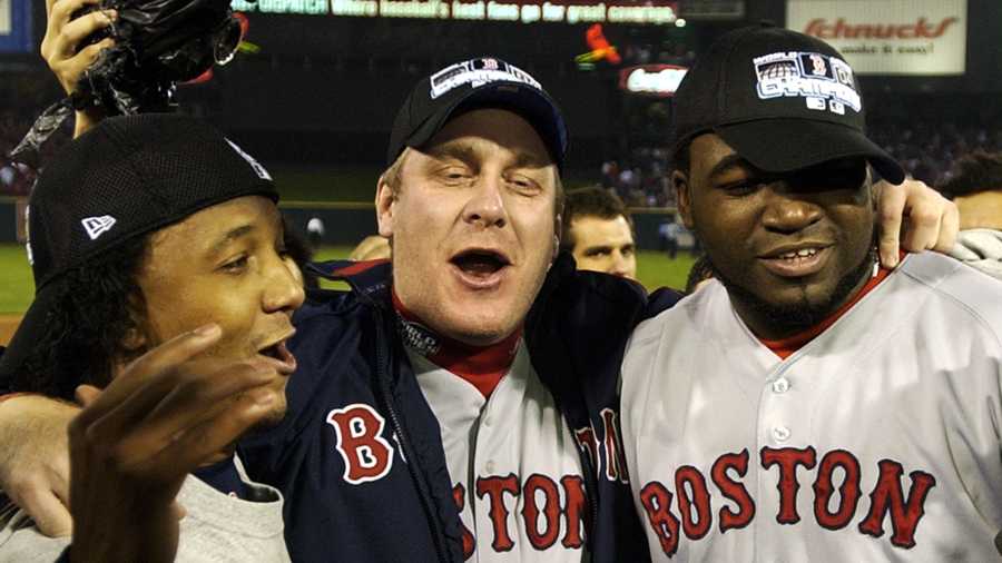 Boston Red Sox players, left to right, Pedro Martinez, Curt Schilling and David Ortiz celebrate after the Red Sox defeated the St. Louis Caridnals 3-0 in Game 4 to win the World Series at Busch Stadium in St. Louis, Wednesday, Oct. 27, 2004. 