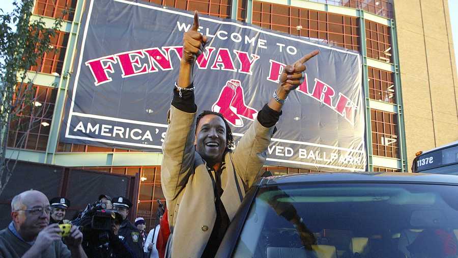 A jubilant Pedro Martinez, of the Boston Red Sox, acknowledges the crowd that gathered around Fenway Park in Boston early Thursday morning Oct. 28, 2004. Martinez and the Boston Red Sox swept the St Louis Cardinals in four games to win their first World Series since 1918. 
