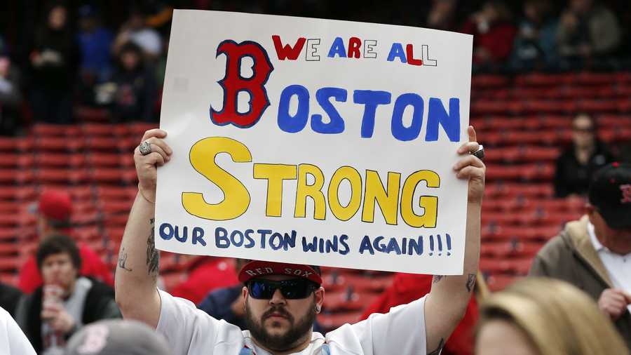 A fan holds a 'Boston Strong' sign before a baseball game between the Boston Red Sox and the Kansas City Royals in Boston, Saturday, April 20, 2013. 