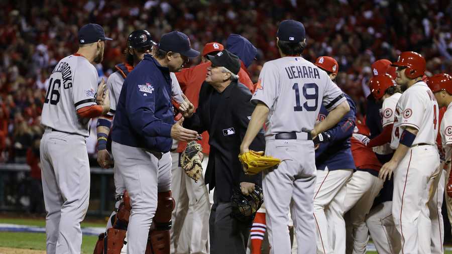 Boston Red Sox manager John Farrell argues with home plate umpire Dana DeMuth after St. Louis Cardinals scored the winning run on an obstruction play during the ninth inning of Game 3 of baseball's World Series Saturday, Oct. 26, 2013, in St. Louis. The Cardinals won 5-4 to take a 2-1 lead in the series. 