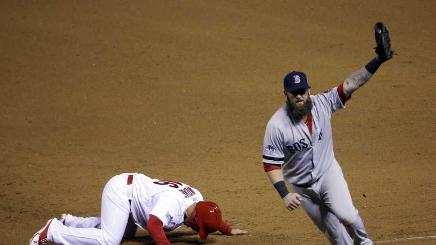 Boston Red Sox first baseman Mike Napoli celebrates after tagging out St. Louis Cardinals' Kolten Wong on a pick-off attempt to end Game 4 of baseball's World Series Sunday, Oct. 27, 2013, in St. Louis. The Red Sox won 4-2 to ties the series at 2-2.