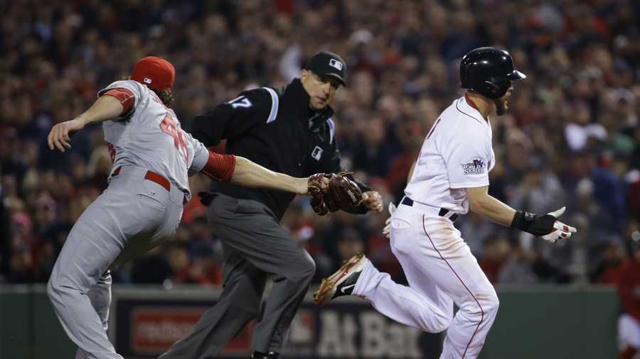 St. Louis Cardinals relief pitcher Kevin Siegrist, left, misses the tag on Boston Red Sox center fielder Jacoby Ellsbury (2) he makes it back to first on a run down during the fifth inning of Game 6 of baseball's World Series Wednesday, Oct. 30, 2013, in Boston.