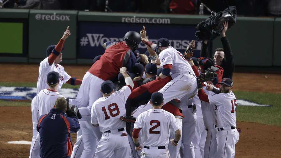 The Boston Red Sox celebrate after defeating the St. Louis Cardinals in Game 6 of baseball's World Series Wednesday, Oct. 30, 2013, in Boston. The Red Sox won 6-1 to win the series. 