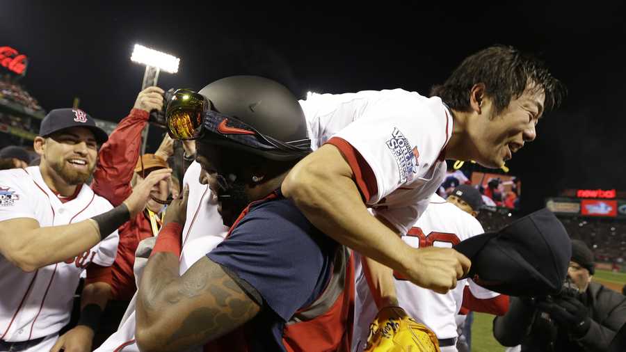 Boston Red Sox's David Ortiz lifts relief pitcher Koji Uehara after Boston defeated the St. Louis Cardinals in Game 6 of baseball's World Series Wednesday, Oct. 30, 2013, in Boston. The Red Sox won 6-1 to win the series. 