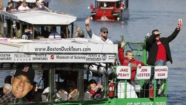 Boston Red Sox's Jon Lester, top center, and Jake Peavy, right, wave from a duck boat on the Charles River during a rolling victory parade celebrating the baseball team's World Series title, Saturday, Nov. 2, 2013, in Boston.