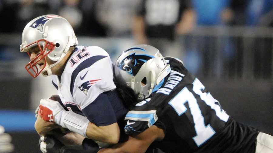 New England Patriots' Tom Brady (12) is sacked by Carolina Panthers' Greg Hardy (76) during the first half of an NFL football game in Charlotte, N.C., Monday, Nov. 18, 2013. (