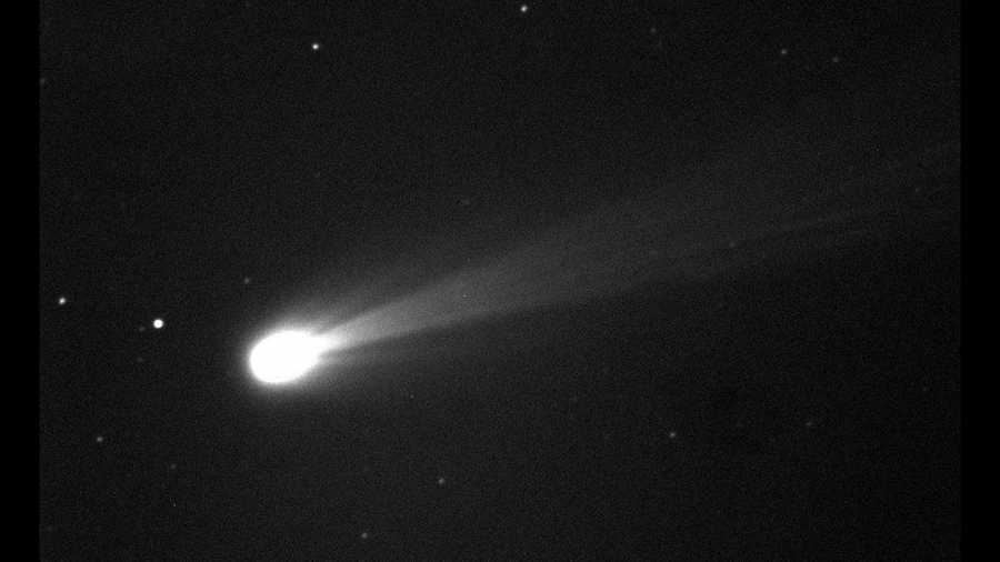 In this photo provided by NASA, Comet ISON shines brightly in this image taken on the morning of Nov. 19, 2013.