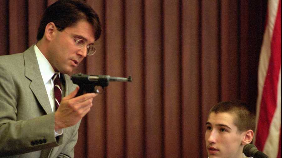 In his second day of testimony at Strafford County Superior Court, in Dover, N.H., Wednesday, May 14, 1997, Jeffrey Dingman, 15, looks on as New Hampshire assistant attorney general John Kacavas shows the .22 caliber pistol that was used to kill Jeffrey's parents, Vance and Eve Dingman. Jeffrey is testifying against his older brother, Robert, 18, who is being tried on two counts of first degree murder. 