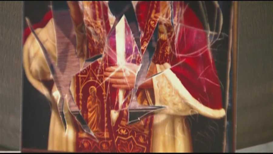 Boston police are looking to identify vandals who broke into a Brighton church and defaced a painting of the pope.