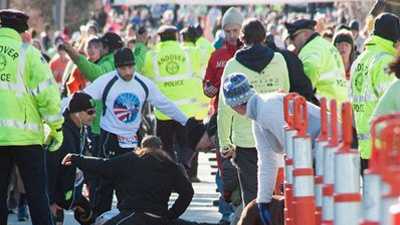 Medical personnel work on Alan Dewhirst after he suffered a heart attack near the end of the Feaster Five road race on Thanksgiving morning in Andover.