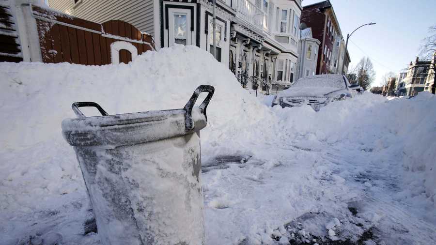A trash can marks the cleared out parking spot of a resident on M street in the South Boston neighborhood of Boston early Sunday, Feb. 10, 2013 in Boston.
