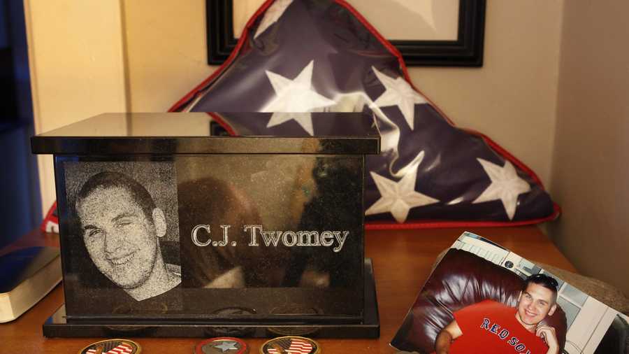 This Dec. 17, 2013, photo shows an urn containing the ashes of C.J. Twomey on a shelf at his parent's home in Auburn, Maine. C.J.'s mother, Hallie Twomey, is asking people to help scatter his ashes throughout the world so he can become part of the world he never got to see.