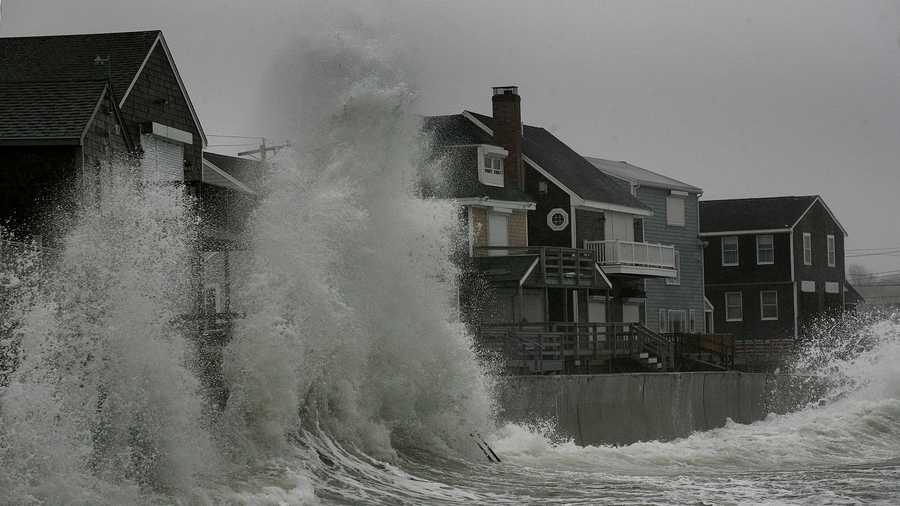 Waves pound the seawalls along the Sand Hills section of Scituate at high tide Thursday.