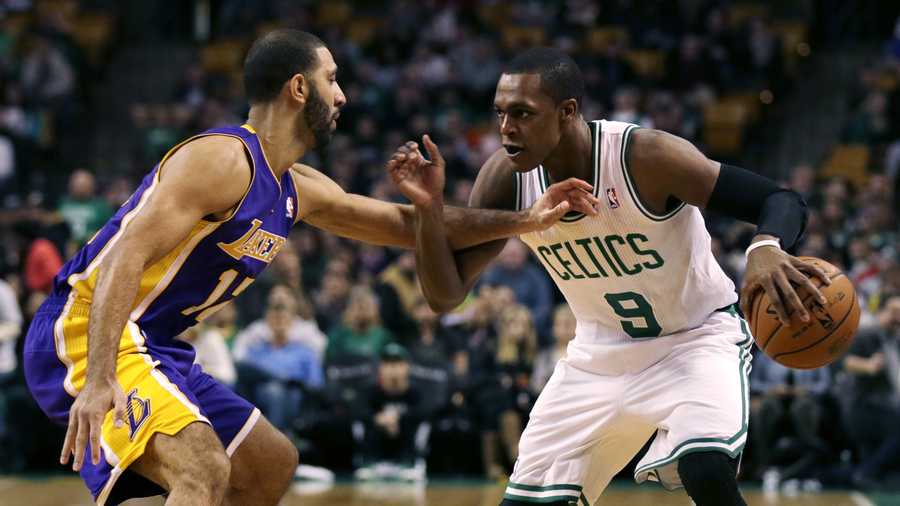Boston Celtics guard Rajon Rondo (9) tries to drive past Los Angeles Lakers point guard Kendall Marshall, left, during the first quarter of an NBA basketball game in Boston, Friday, Jan. 17, 2014. Rondo returned to the court for the first time this season, after undergoing surgery on his right knee.