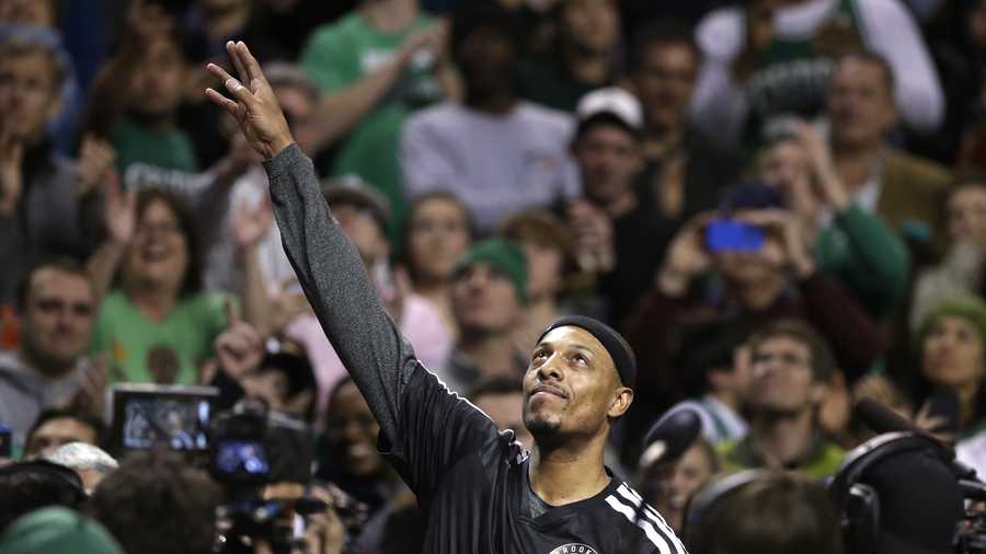 Brooklyn Nets forward Paul Pierce, center, formerly of the Boston Celtics, waves to the crowd during a tribute to him in an NBA basketball game against the Boston Celtics, Sunday, Jan. 26, 2014, in Boston.