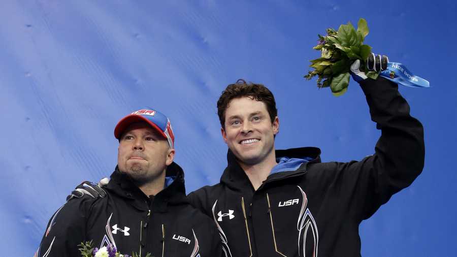 The team from the United States USA-1, piloted by Steven Holcomb (left) and brakeman Steven Langton, celebrate their bronze medal win after the men's two-man bobsled competition at the 2014 Winter Olympics, Monday, Feb. 17, 2014, in Krasnaya Polyana, Russia.