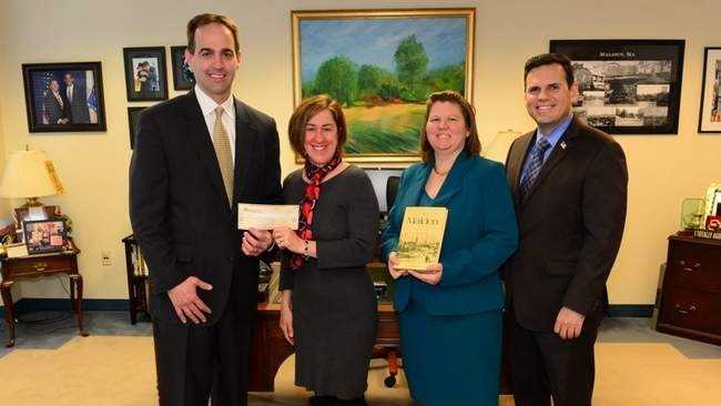 Michael Richards (left) recently donated $1,500 to a local charity, as payment for a long-overdue library book. Also in the photo are Housing Families Community Outreach Coordinator Patty Kelly, Malden Public Library Director Dora St. Martin, Mayor Gary Christenson COURTESY PHOTO