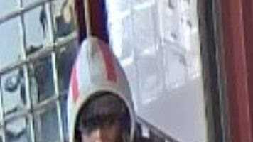 Transit police are seeking the public's help in finding a man who robbed a woman of her bag at an MBTA station.