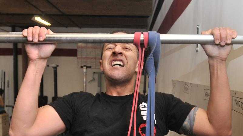 Jesse Stanley does pull-ups at Easthampton Crossfit in Easthampton. An avid obstacle racer, he's gearing up for the Death Race, an extreme obstacle race to be held in June in Pittsfield, Vt. Competitors don't know which obstacles they'll encounter, but previous races have required participants to chop wood, dive for cinder blocks and crawl under barbed wire.