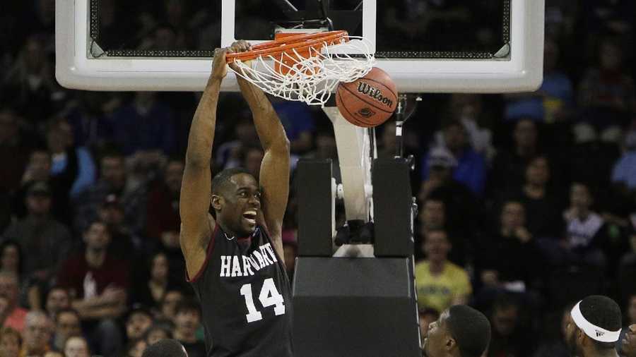 Harvard’s Steve Moundou-Missi (14) dunks against Cincinnati in the second half during the second-round of the NCAA men's college basketball tournament in Spokane, Wash., Thursday, March 20, 2014.