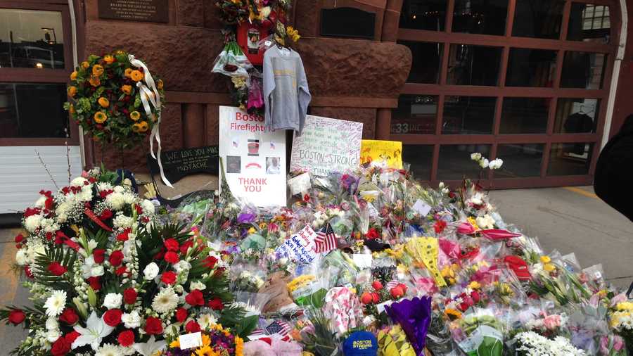 The memorial grows outside Engine 33 on Boylston Street.