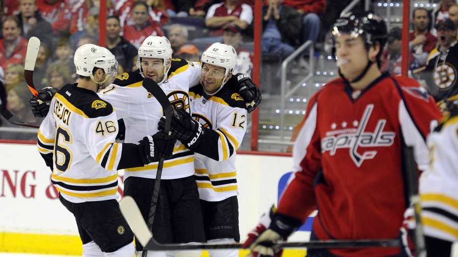 Boston Bruins right wing Jarome Iginla (12) celebrates his goal against the Washington Capitals with David Krejci (46), of the Czech Republic, and Andrej Meszaros (41) during the second period of an NHL hockey game, Saturday, March 29, 2014, in Washington. (AP Photo/Nick Wass)