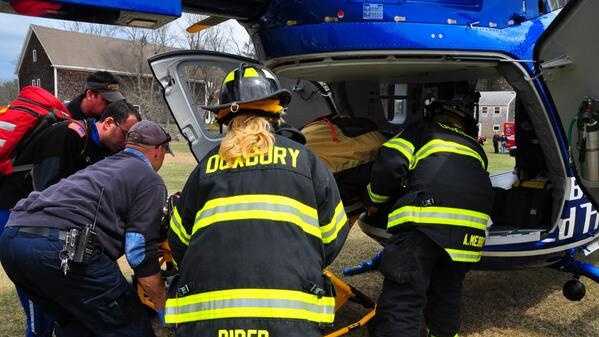 Images: Crews rescue man trapped under tree