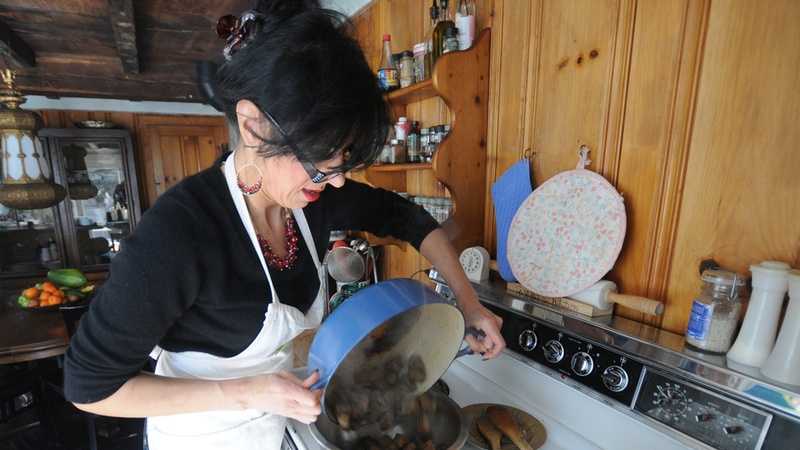 Sheila Mullins prepares curried beef in her Newburyport kitchen before the March 7 event at the Custom House Maritime Museum.