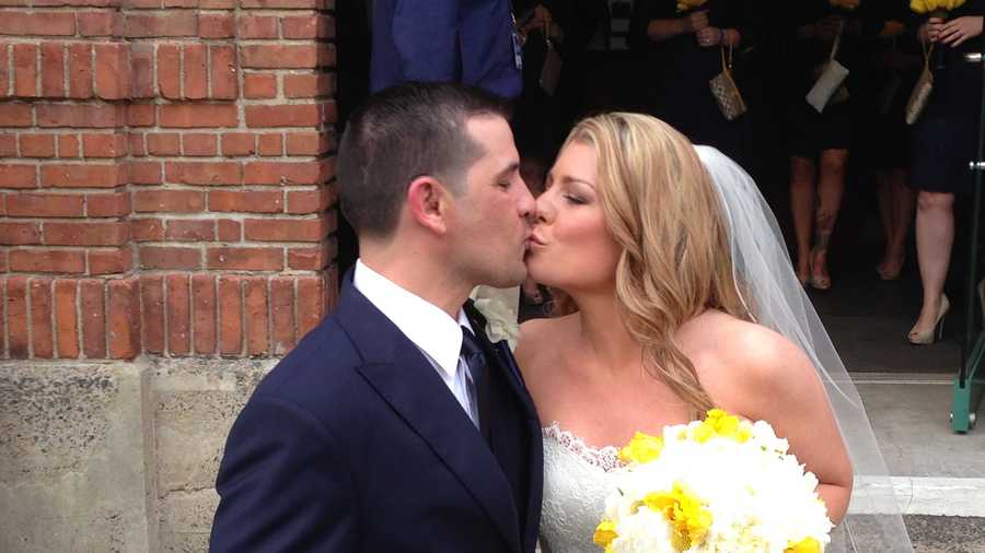 The pair has been engaged for 7 years. They pose outside Fenway Park for a kiss. 