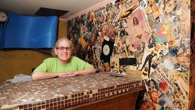 Patty Tripp of West Bridgewater stands next to the iconic mural in the basement of her home.
