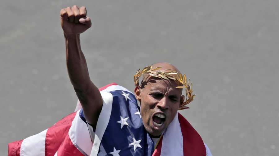 With an American flag wrapped around him, Meb Keflezighi celebrates his victory in the 118th Boston Marathon Monday, April 21, 2014 in Boston.