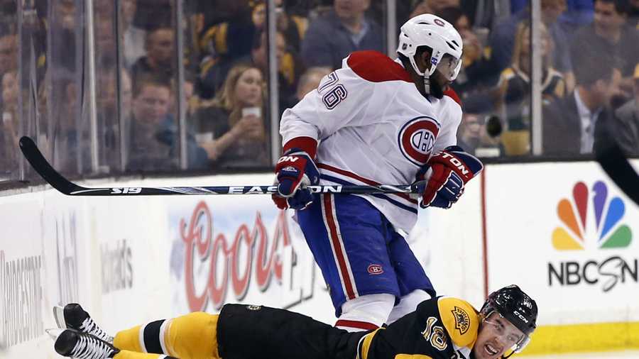 Boston Bruins right wing Reilly Smith (18) falls to the ice after crashing with Montreal Canadiens defenseman P.K. Subban (76) during the first period in Game 1 of an NHL hockey second-round playoff series in Boston, Thursday, May 1, 2014.