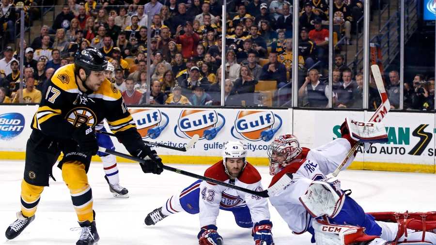 Montreal Canadiens goalie Carey Price (31) and defenseman Mike Weaver (43) both dive to make a save against a shot by Boston Bruins left wing Milan Lucic (17) during the second period in Game 2 of an NHL hockey second-round playoff series in Boston, Saturday, May 3, 2014. (AP Photo/Elise Amendola)