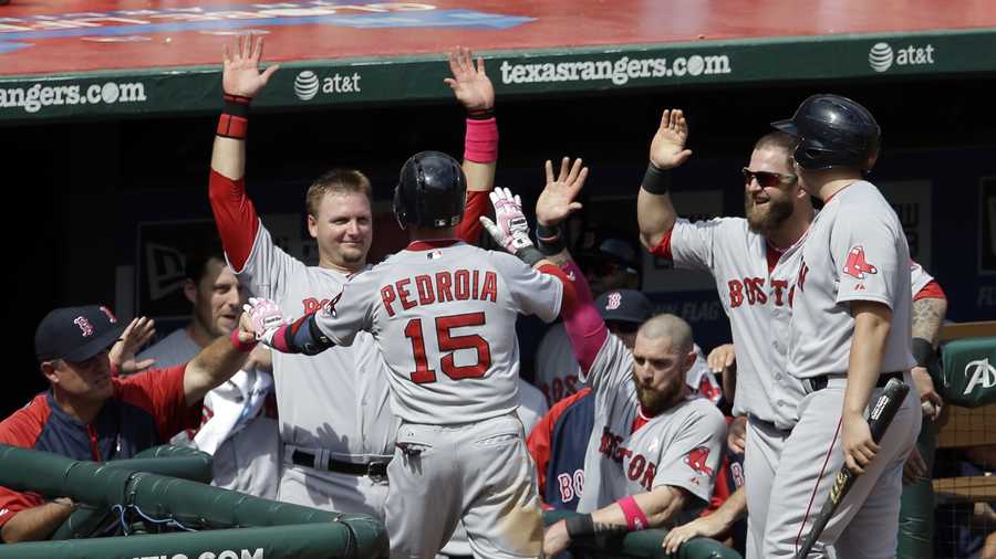 Boston Red Sox's Dustin Pedroia (15) is congratulated at the top of the dugout by manager John Farrell, left,catcher A.J. Pierzynski and Mike Napoli, second from right, following his solo home run off Texas Rangers' Robbie Ross in the seventh inning of a baseball game on Sunday, May 11, 2014, in Arlington, Texas. (AP Photo/Tony Gutierrez)
